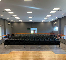 Fixed floor-standing chairs and benches with tip-up seat for conference and congress halls